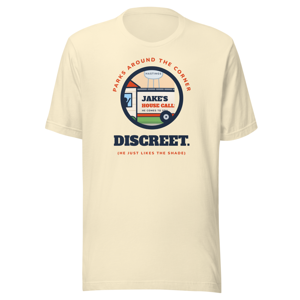 Cream tee with the van hiding behind the house in a round patch, PARKS AROUND THE CORNER arched over it